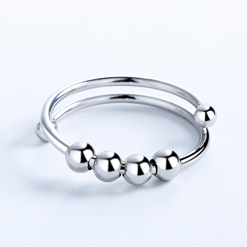 "Elegant justerbar ångestring med 4 roterbara metallpärlor för mindfulness och stresslindring, perfekt för kvinnors accessoar