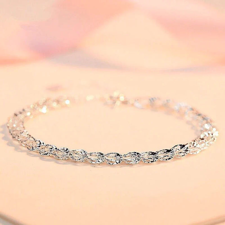 "Elegant justerbart Phoenix armband i guld/silver med unikt fjädermotiv, perfekt kvinnligt smycke för alla tillfällen."