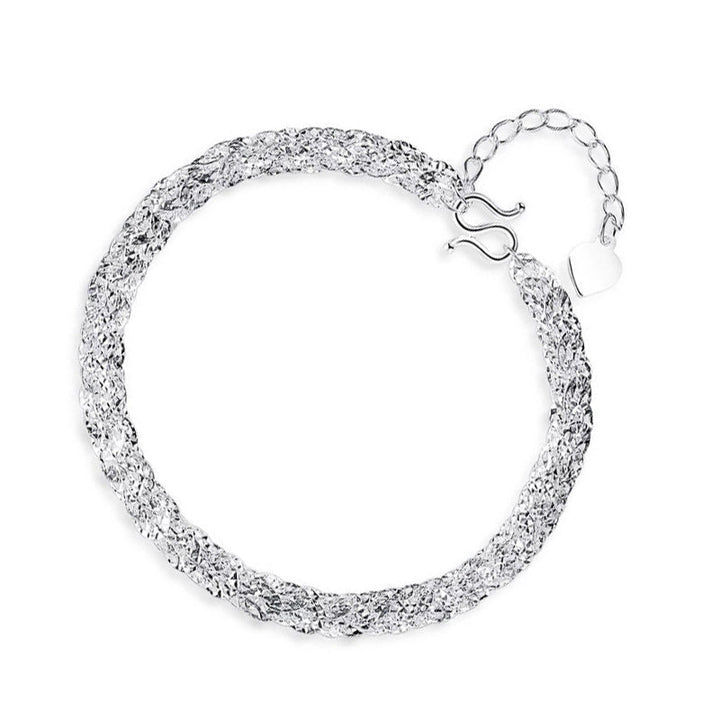 "Elegant justerbart Phoenix armband i guld/silver med unikt fjädermotiv, perfekt kvinnligt smycke för alla tillfällen."