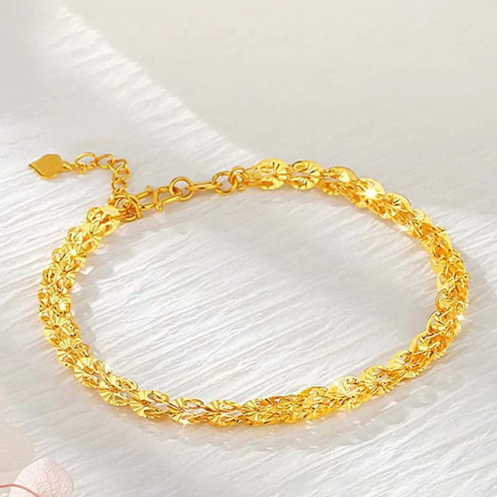 "Elegant justerbart Phoenix armband i guld/silver med unikt fjädermotiv, perfekt kvinnligt smycke för alla tillfällen."