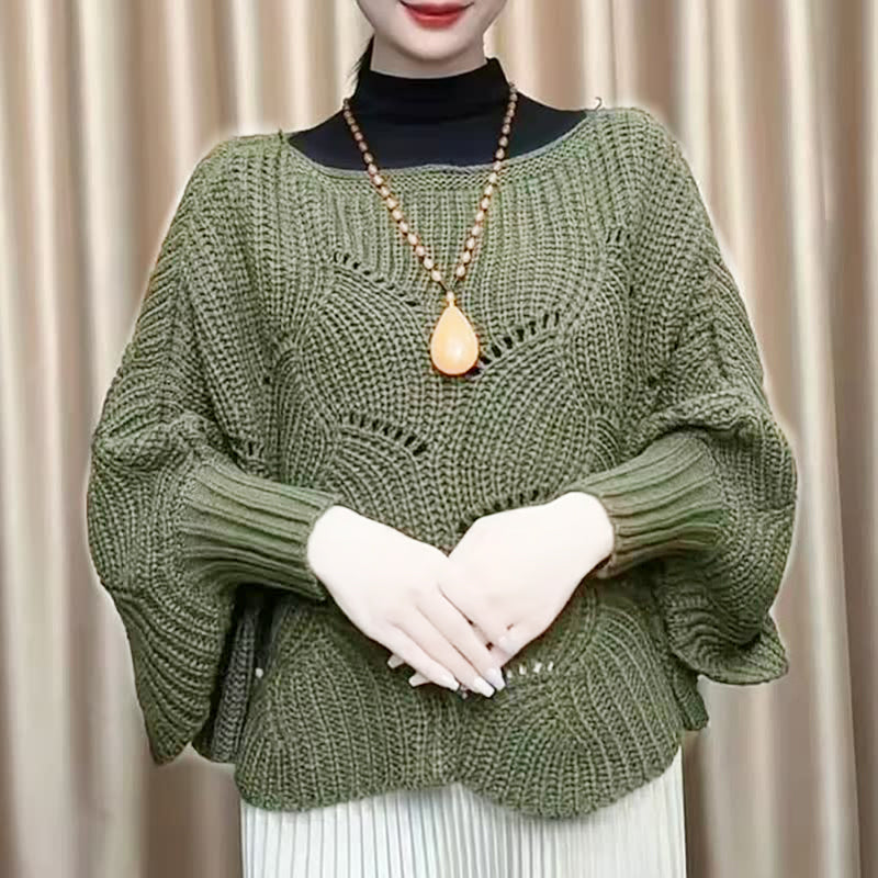"Elegant långstickad damponcho med fladdermusärmar, ger stil och värme, i mjuk grå ton."