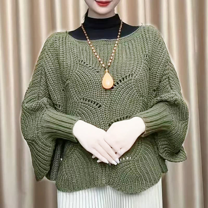 "Elegant långstickad damponcho med fladdermusärmar, ger stil och värme, i mjuk grå ton."