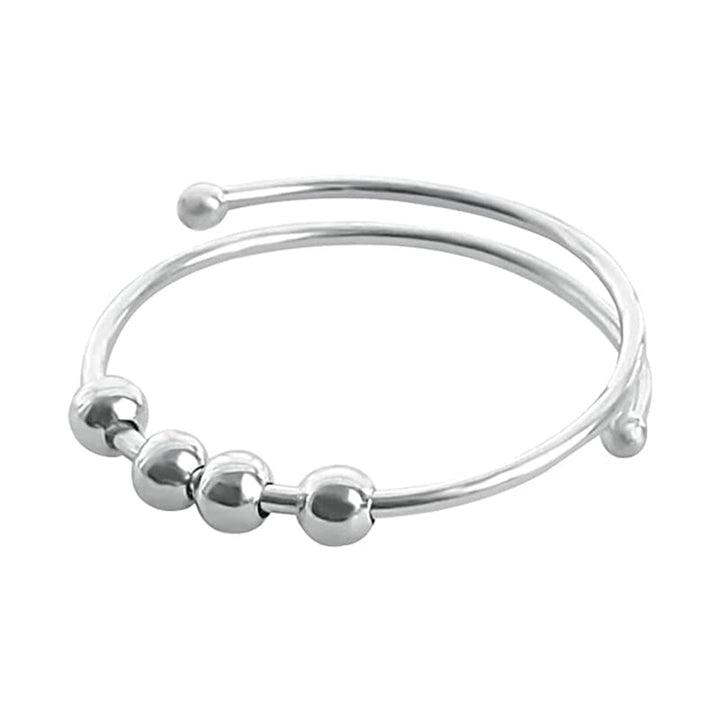 "Elegant och justerbar ångestring i silver för damer, med roterbar design för stil och stresslindring."