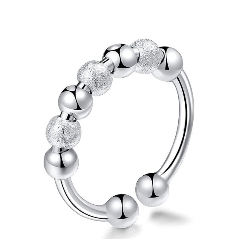 "Elegant och justerbar ångestring i silver för damer, med roterbar design för stil och stresslindring."