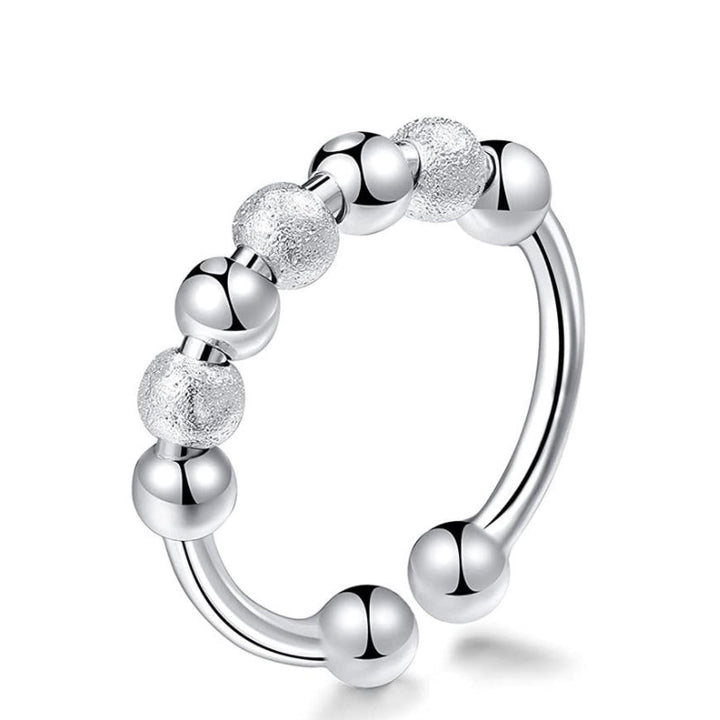 "Elegant och justerbar ångestring i silver för damer, med roterbar design för stil och stresslindring."