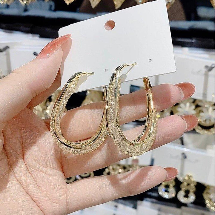 Elegant ovala damhängen i guld och silver, med glänsande yta. Perfekta för både vardag och speciella tillfällen.