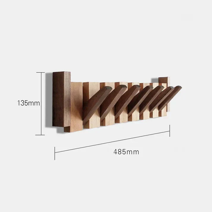 Platsbesparande pianohängare i valnötsträ. Stilfull kroklist som organiserar hallen med elegans och design.