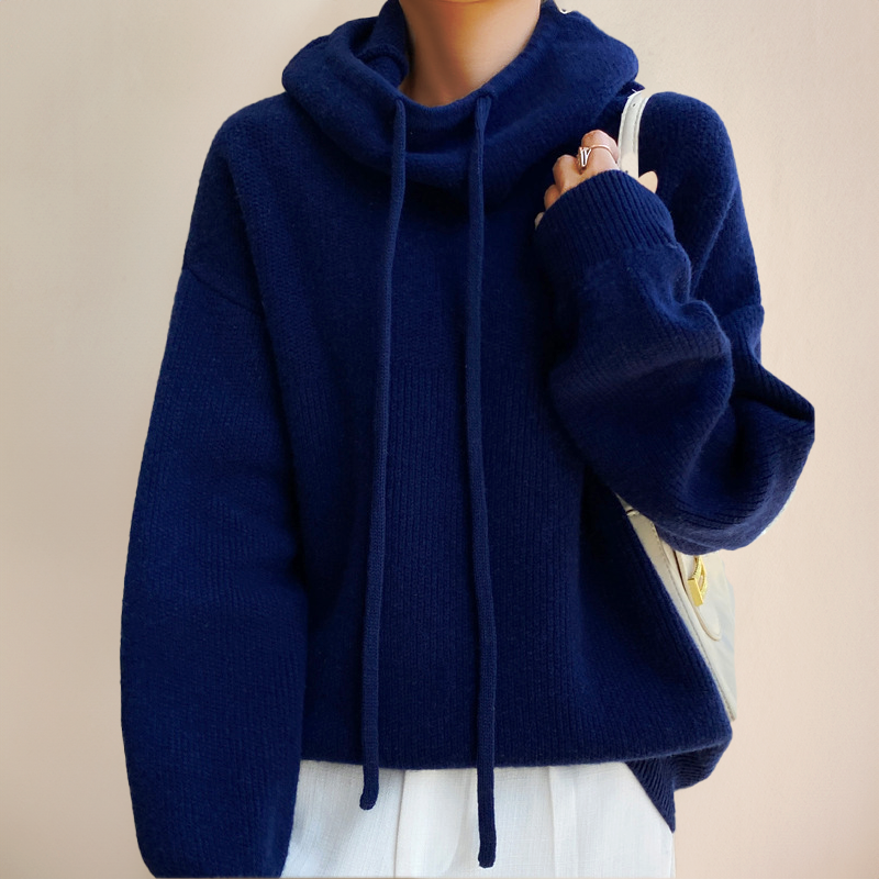 Helkroppsbild av en modell som bär den eleganta polo tröjan, stylad för en chic höst/vinter look.
