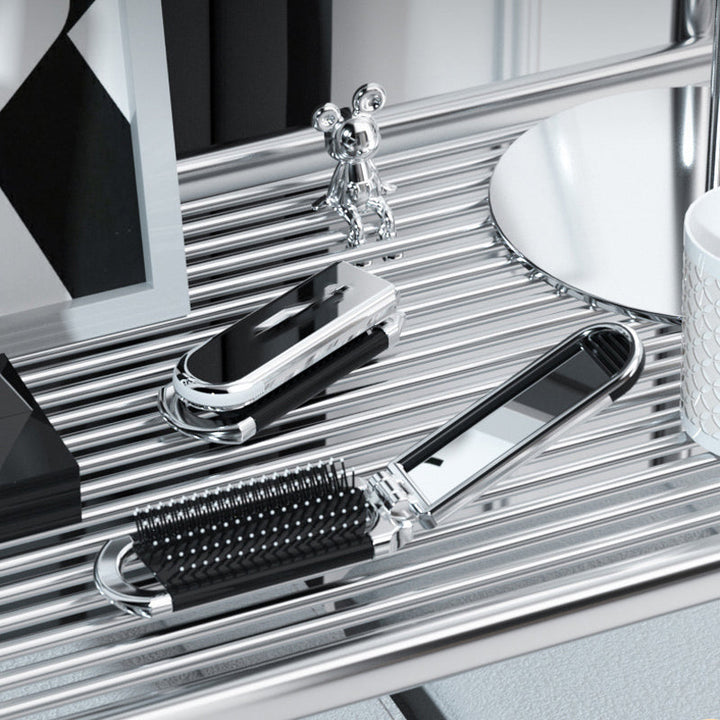"Elegant resevänlig silver spegelhårborste, unisex design, kompakt och hopfällbar med spegel för enkel stiljustering."
