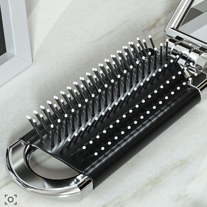 "Elegant resevänlig silver spegelhårborste, unisex design, kompakt och hopfällbar med spegel för enkel stiljustering."
