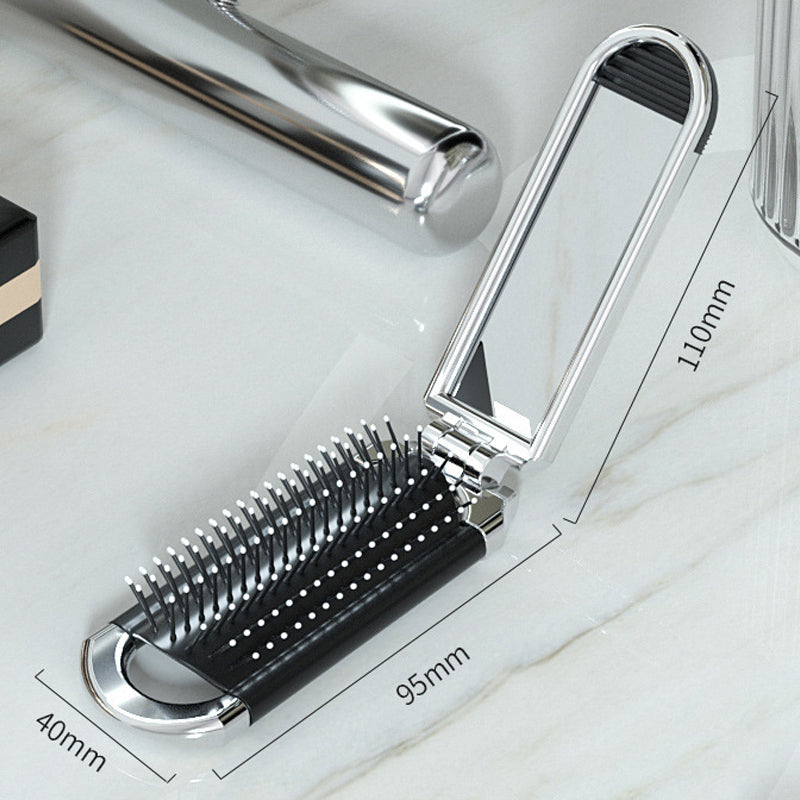 "Elegant resevänlig silver spegelhårborste, unisex design, kompakt och hopfällbar med spegel för enkel stiljustering."