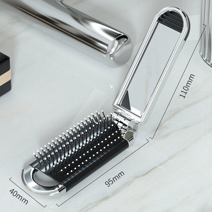 "Elegant resevänlig silver spegelhårborste, unisex design, kompakt och hopfällbar med spegel för enkel stiljustering."