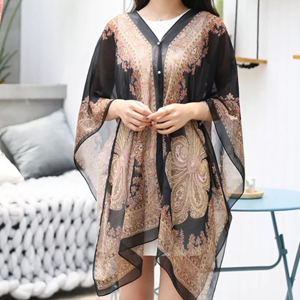 Mångsidig svart damponcho som elegant sjal. Perfekt accessoar för höst, vår och svala sommarkvällar.