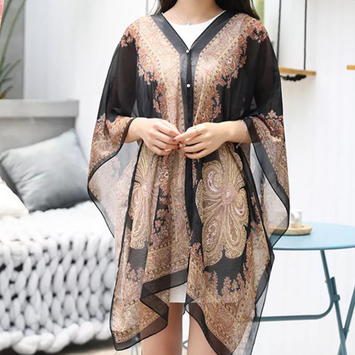Mångsidig svart damponcho som elegant sjal. Perfekt accessoar för höst, vår och svala sommarkvällar.