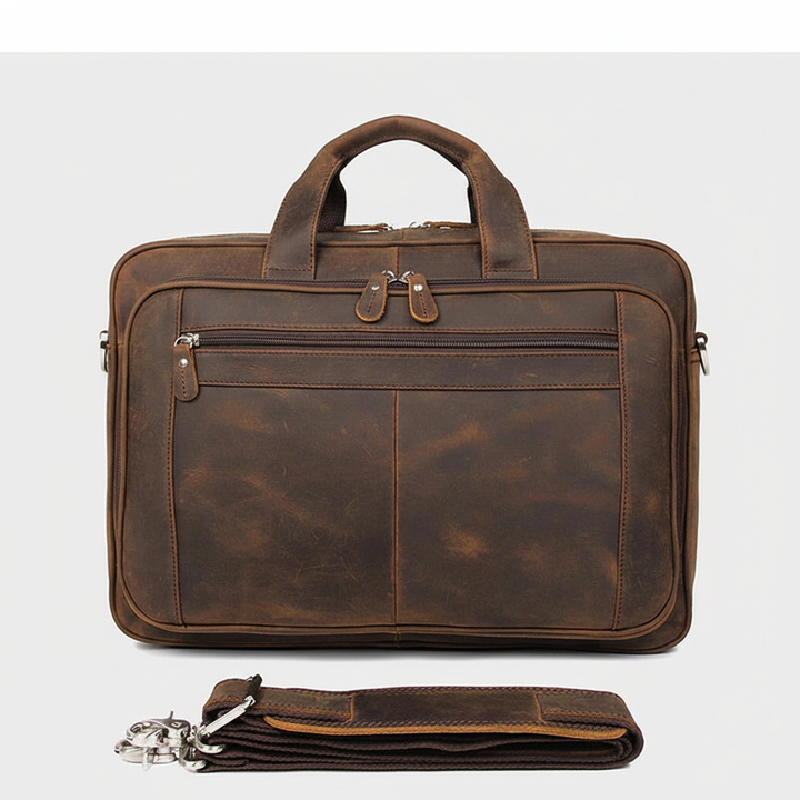 Rymlig, organiserad läderportfölj och arbetsväska. Perfekt för laptop, dokument och affärsresor; inkluderar axelrem.