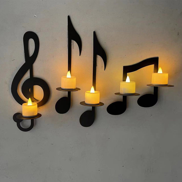 "Elegant svart metall väggmonterad musiknot ljusstake; kombinerar musikinspirerad design med stilfull dekoration."