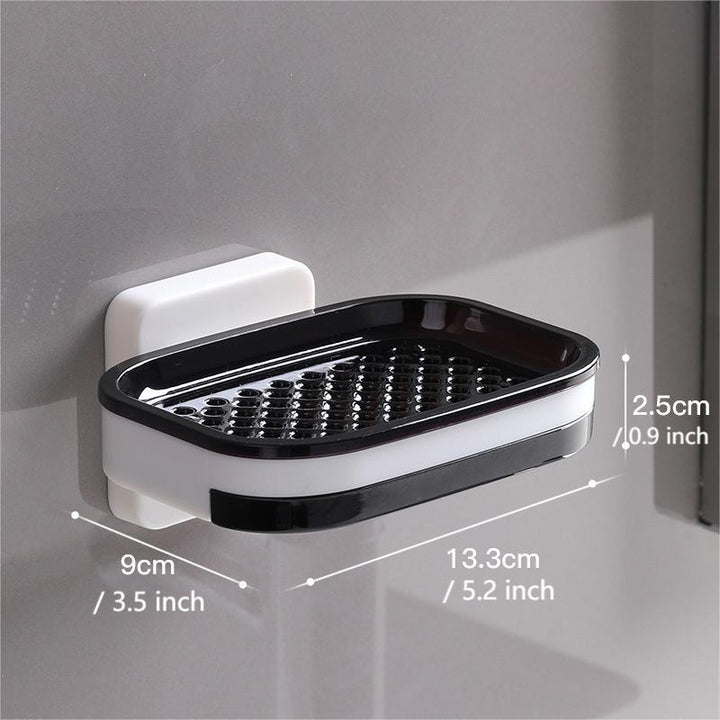 "Elegant svart och grå tvålkopp med avtappningsbricka, stilren design, glansig bakgrund, perfekt för badrumshylla."