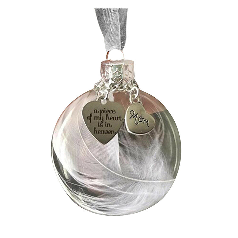 "Elegant transparent julkula med vit fjäder och gravering, perfekt för juldekoration eller som en omtänksam gåva."