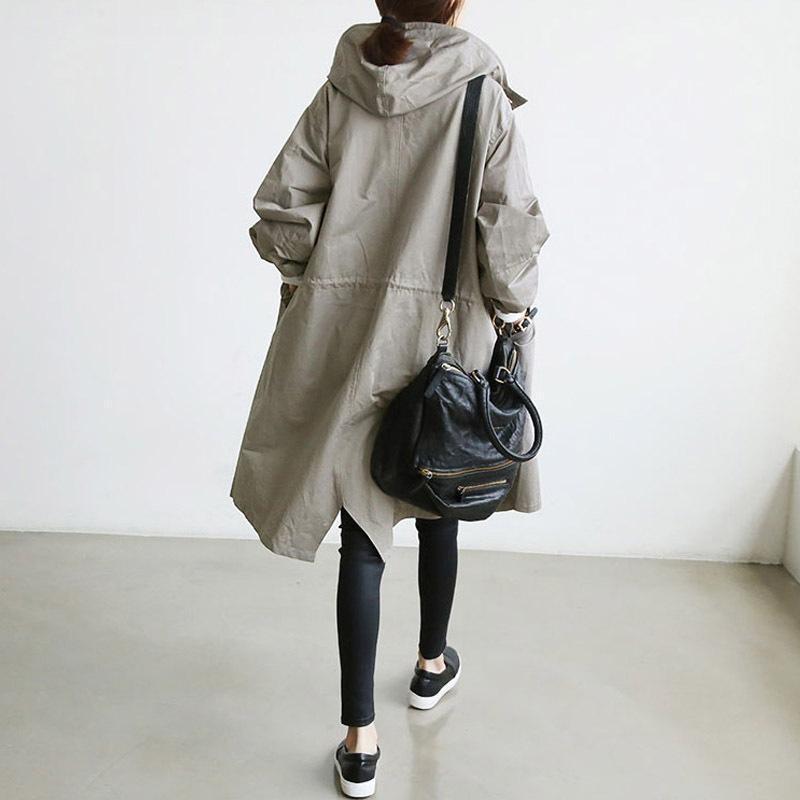 "Elegant vattentät trenchcoat för kvinnor med dragsko, elastiska manschetter och avslappnad passform i beige."