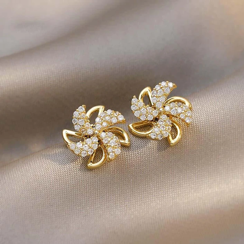 "Eleganta roterande väderkvarnörhängen i koppar och zirkon för kvinnor, gyllene eller silver, 1,1 cm, unika design."