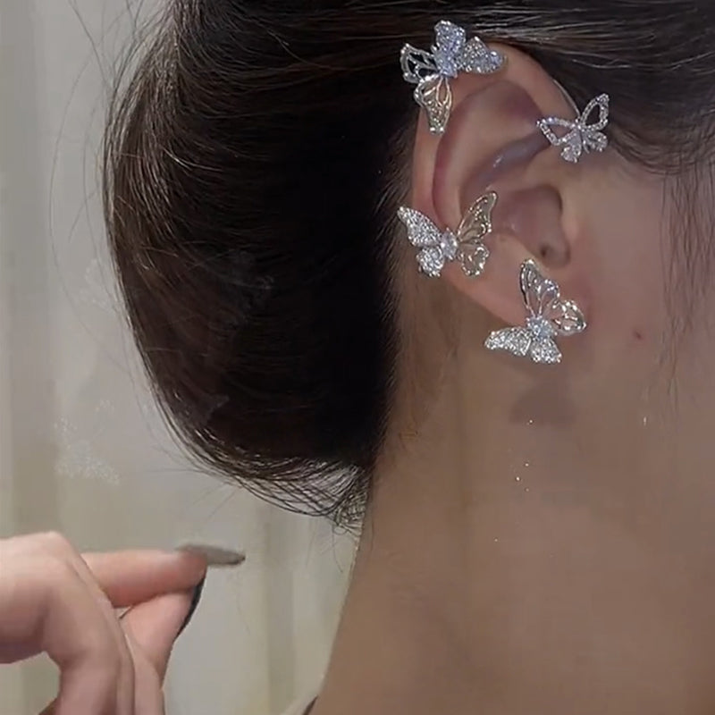 "Eleganta zirkon fjäril örhängen för damer utan piercing, silverfärgade med koppar och gnistrande zirkoner."