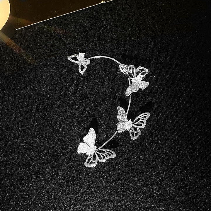 "Eleganta zirkon fjäril örhängen för damer utan piercing, silverfärgade med koppar och gnistrande zirkoner."