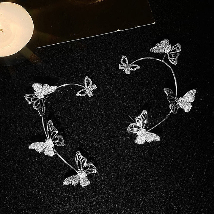 "Eleganta zirkon fjäril örhängen för damer utan piercing, silverfärgade med koppar och gnistrande zirkoner."