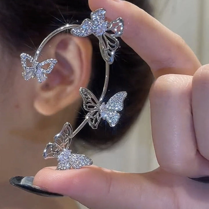 "Eleganta zirkon fjäril örhängen för damer utan piercing, silverfärgade med koppar och gnistrande zirkoner."