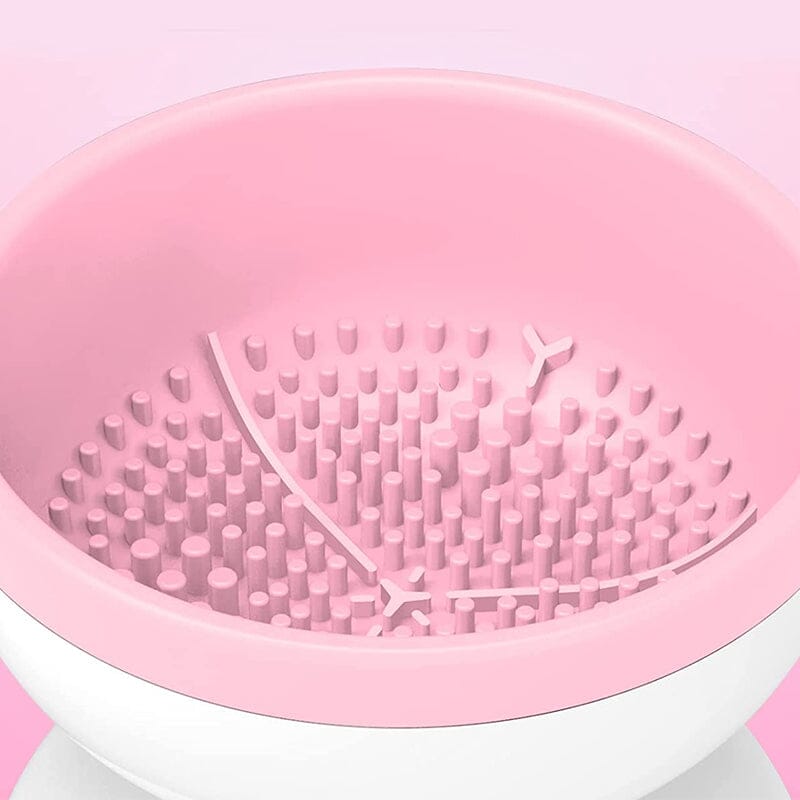 "Elektrisk makeupborstrengörare i rosa, kompakt med rund design, perfekt för effektiv borstvård på resor."