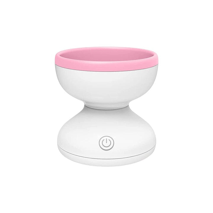 "Elektrisk makeupborstrengörare i rosa, kompakt med rund design, perfekt för effektiv borstvård på resor."