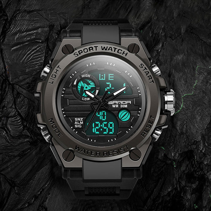 "Elektronisk dubbeltskärmsklocka, svart och armégrön, med silver och guld detaljer, för utomhusbruk och tidszonssynk."