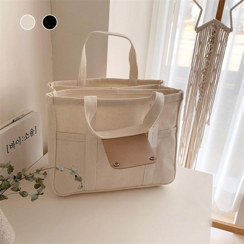 "Enfärgad dam tygkasse i robust canvas, med breda handtag och stor kapacitet. Perfekt som chic och hållbar väska."