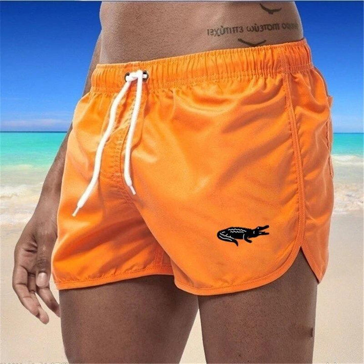 "Enfärgade herr badshorts med krokodilmönster i polyester, perfekt för sommar, tillgängliga i flera färger."