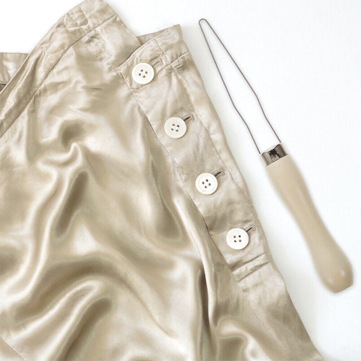 "Ergonomisk knappkrok i metall med pekfingeröppning för enkel knapphantering, idealisk för begränsad fingerfärdighet."