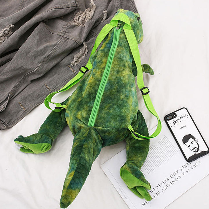 "Färgglad barnryggsäck formad som en dinosaurie, justerbar och vattentät med vadderad ryggpanel och meshtyg."