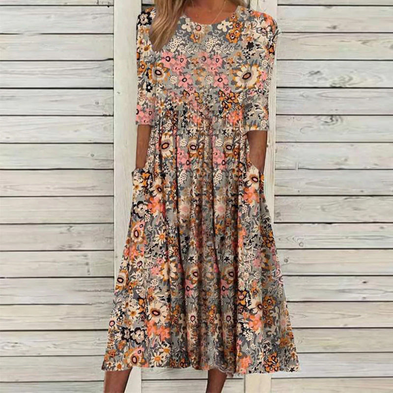 "Färgglad blommig midikjol i polyester med A-linje och praktiska fickor, framifrån vy för en sofistikerad look."