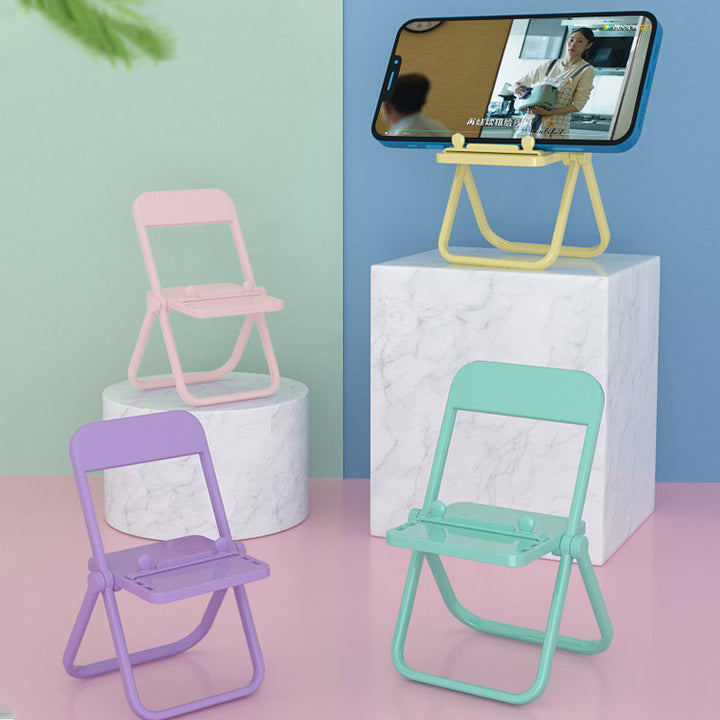 "Färgglad telefonhållare i stolform, kompakt design, finns i olika färger, perfekt för skrivbord, stilfull och praktisk."