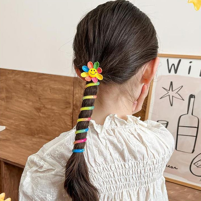 "Färgglada, elastiska hårband för barn med tecknade motiv och blommönster i flera färger, perfekta för daglig användning."