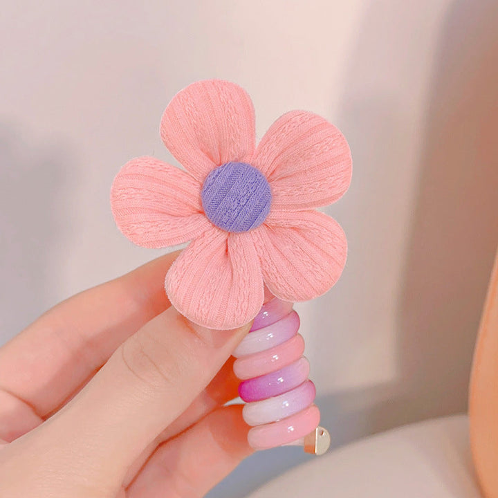 "Färgglada, elastiska hårband för barn med tecknade motiv och blommönster i flera färger, perfekta för daglig användning."
