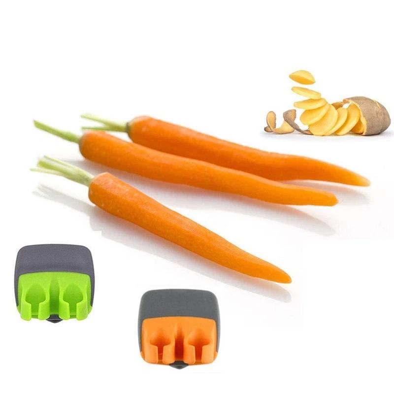 "Fingerskalare i grön och orange, ergonomisk design, kökspryl för säker och enkel hantering av frukt och grönsaker."