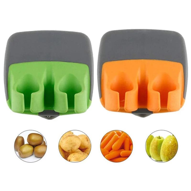 "Fingerskalare i grön och orange, ergonomisk design, kökspryl för säker och enkel hantering av frukt och grönsaker."