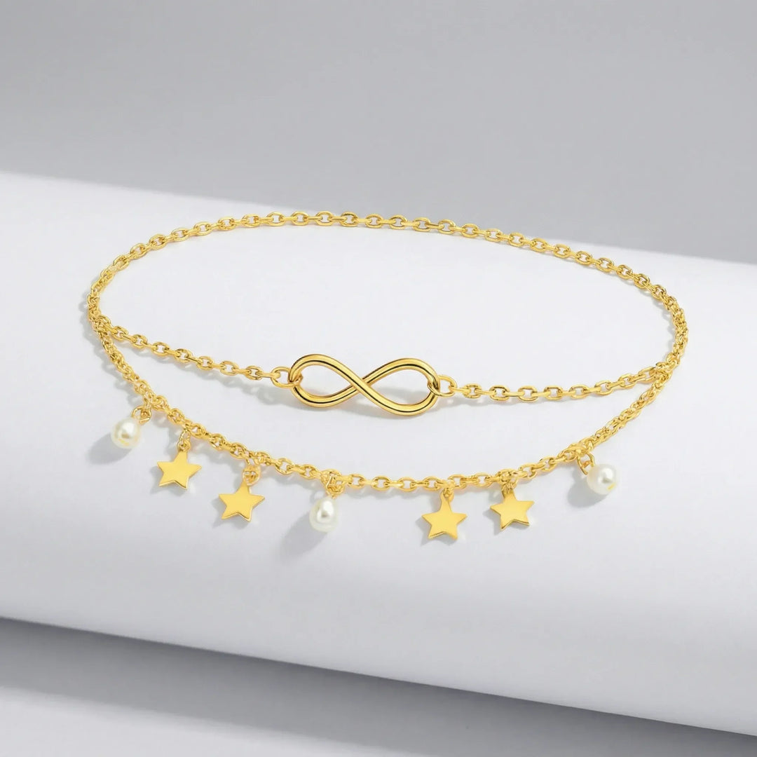 Guld & silver flerlagig fotlänk för dam. Unik design med stjärnhängen, pärlor och justerbar kedja.