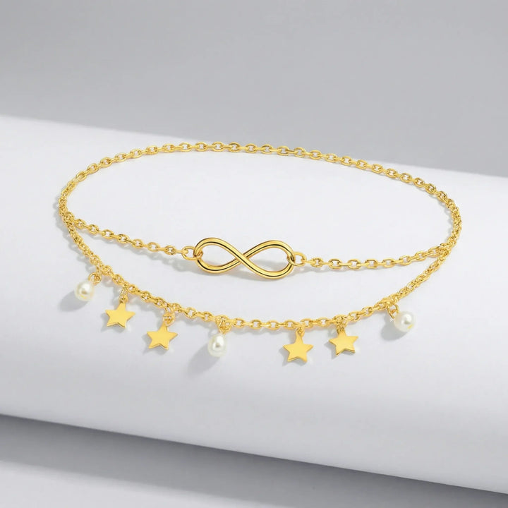 Guld & silver flerlagig fotlänk för dam. Unik design med stjärnhängen, pärlor och justerbar kedja.