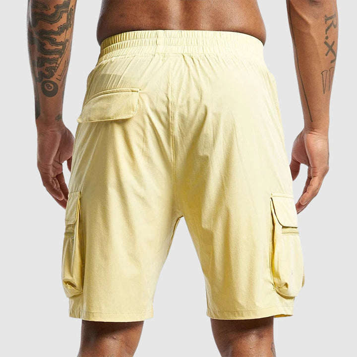 Man bär svarta herrshorts med lastfickor, demonstrerar bekväm passform för utomhusbruk.