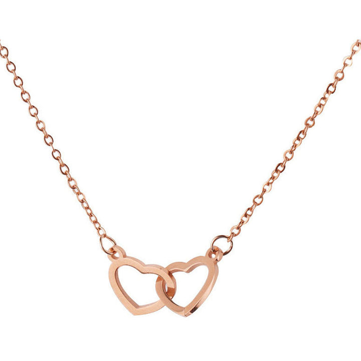 "Halsband för kvinnor med två sammanflätade hjärtan i titan stål, elegant romantisk design i guld, roséguld eller silver."