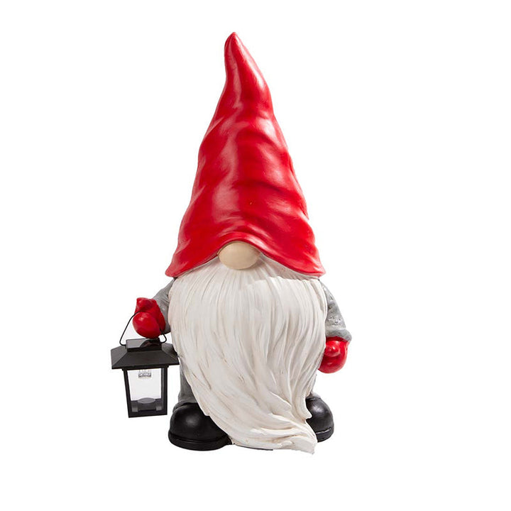 "Handgjord snögubbe juldekoration med LED-lykta, snöhatt, röd halsduk i trädgård, för magisk julstämning i hemmet."