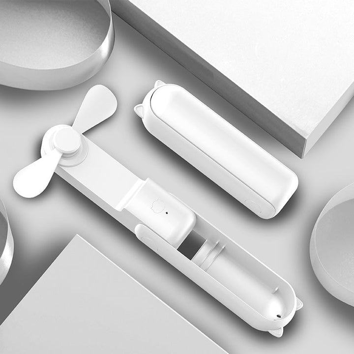 "Handhållen bärbar fläkt med USB-laddning, stilren design utan synliga vindblad, finns i flera färger."