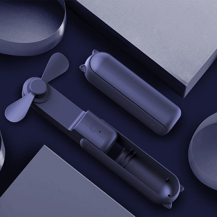 "Handhållen bärbar fläkt med USB-laddning, stilren design utan synliga vindblad, finns i flera färger."