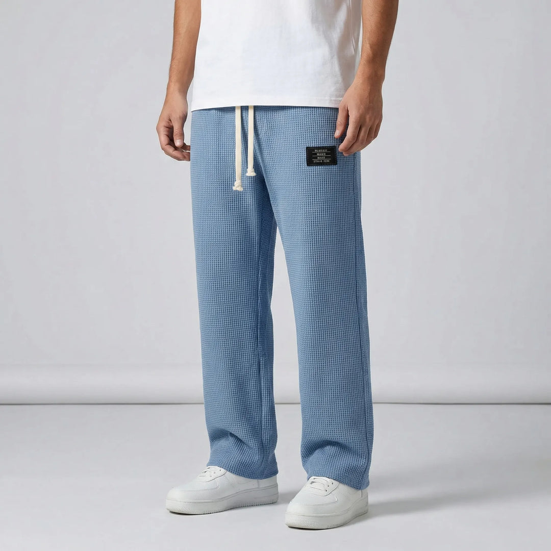 Herrbyxor med dragsko: Gråa avslappnade sweatpants i bekväm våffelstruktur, perfekt för ledig stil.