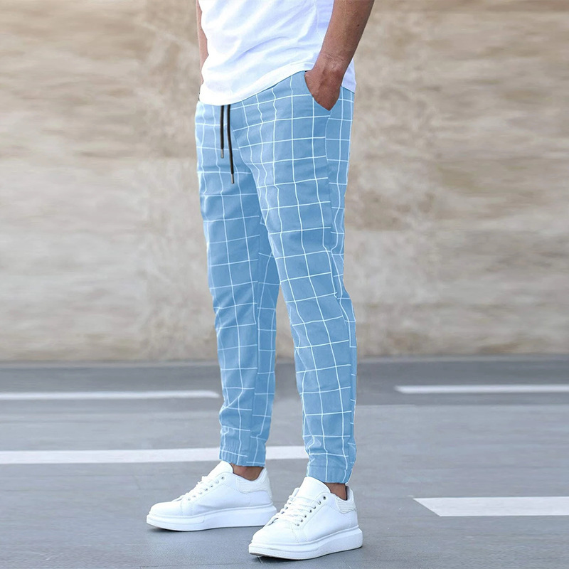 Modell visar rutiga herrjoggingbyxor med matchande hoodtröja, för modern och avslappnad look.